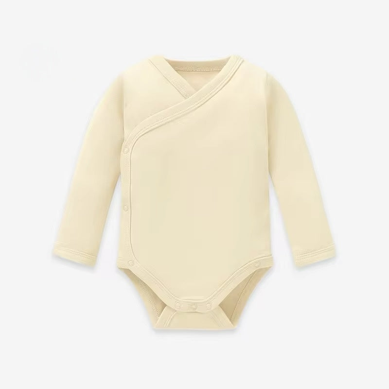 Beige baby bodysuit with long sleeves on a white background