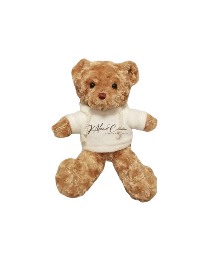 Plush teddy bear wearing a white shirt with text on a white background