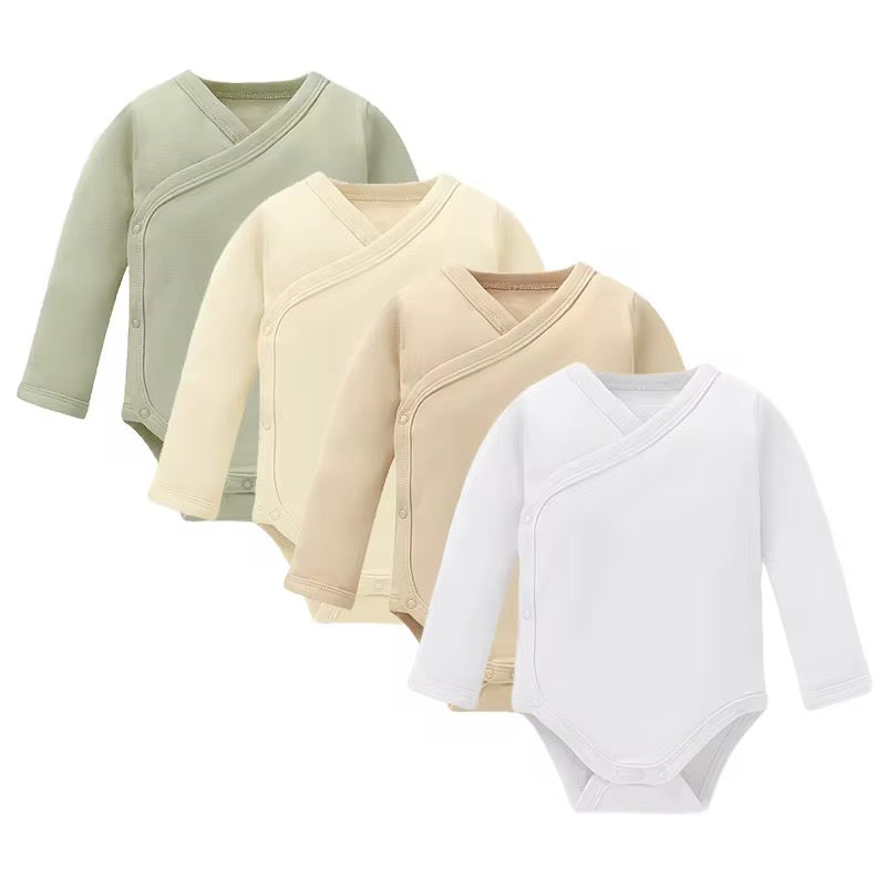 Three baby bodysuits in green, beige, and white on a white background
