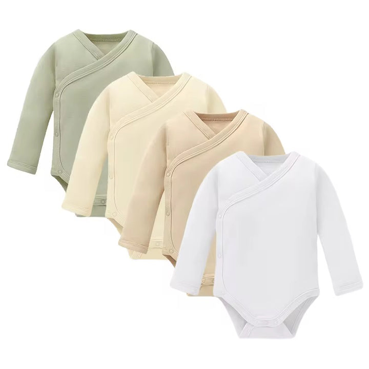 Three baby bodysuits in green, beige, and white on a white background